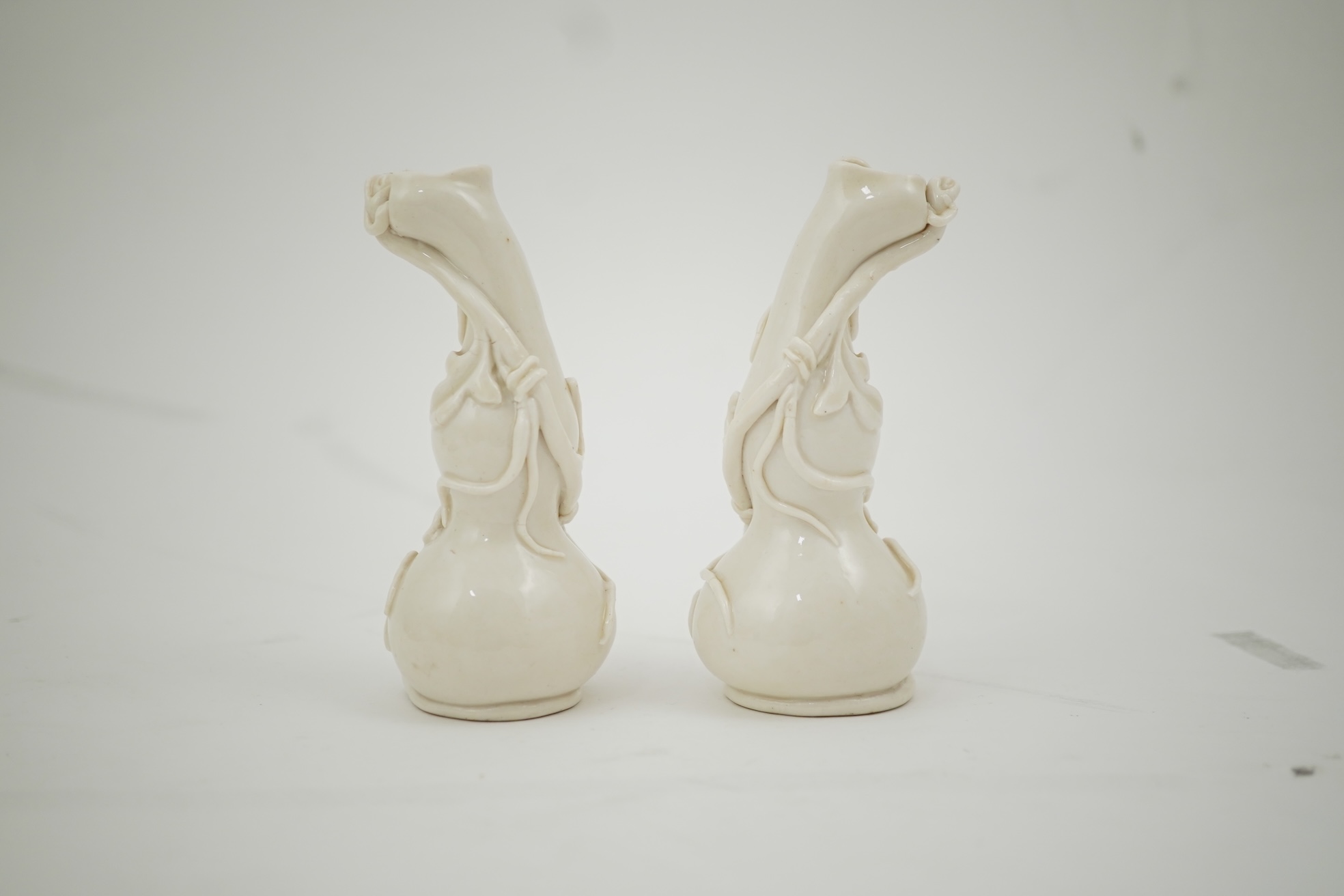 A pair of Chinese blanc-de-chine gourd-shaped vases, Dehua kilns, Qing dynasty